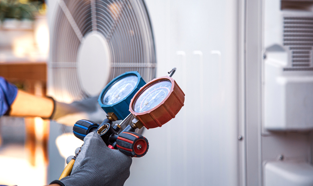 hvac technician checking refrigerant levels