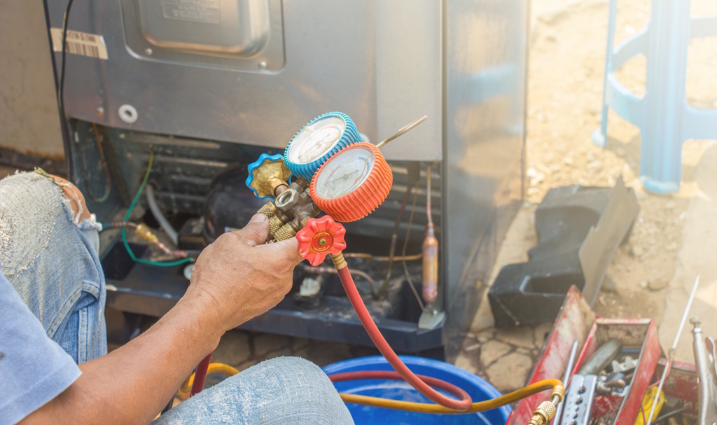 hvac worker fixing ac unit